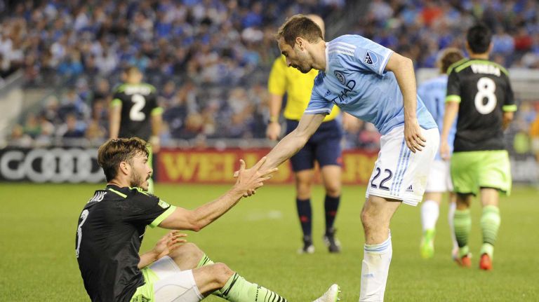 New York City FC vs. Sounders 27 New York City FC midfielder Pablo lvarez (22) helps up Seattle Sounders FC midfielder Brad Evans (3) in an MLS game at Yankee Stadium on Sunday, May 3, 2015.