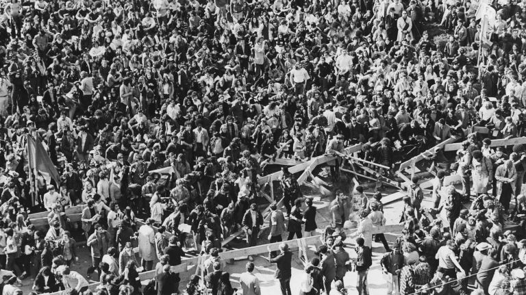 Crowds at Moratorium Rally in Bryant Park in New York City trying for a closer view push their way through the barriers. (April 15, 1970)