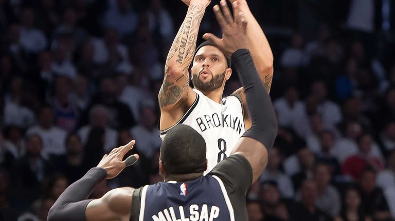 The Brooklyn Nets' Deron Williams shoots a jump shot over Paul Millsap of the Atlanta Hawks in the third quarter of Game 4 of the first round of the NBA playoffs at the Barclays Center on Monday, April 27, 2015.