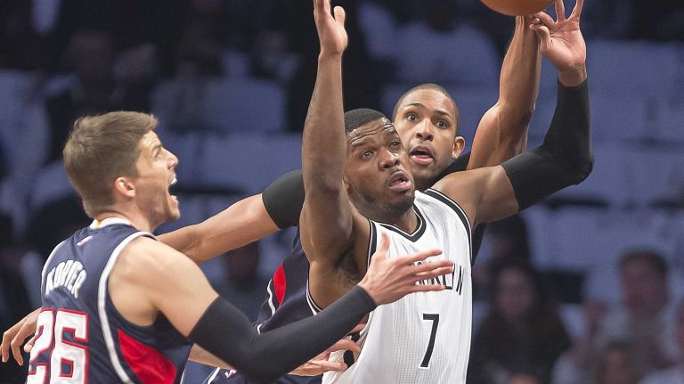 The Brooklyn Nets' Joe Johnson is double-teamed by Kyle Korver and Al Horford of the Atlanta Hawks in the first quarter of Game 4 during the first round of the NBA playoffs at the Barclays Center on Monday, April 27, 2015.