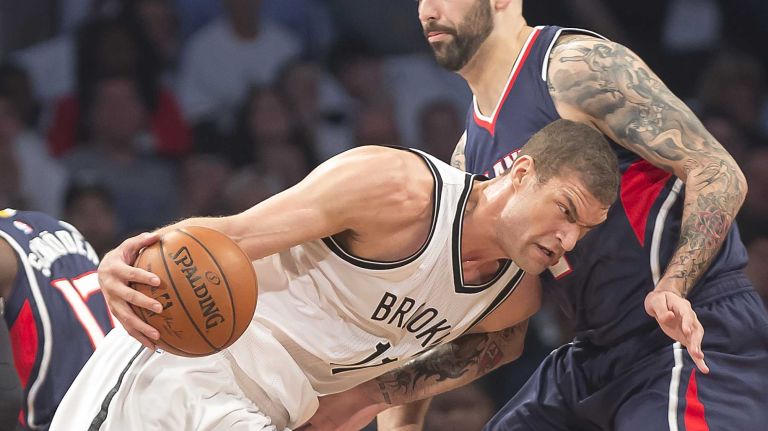 The Brooklyn Nets' Brook Lopez tries to drive against Pero Antic of the Atlanta Hawks in the first quarter of Game 4 during the first round of the NBA playoffs at the Barclays Center on Monday, April 27, 2015.