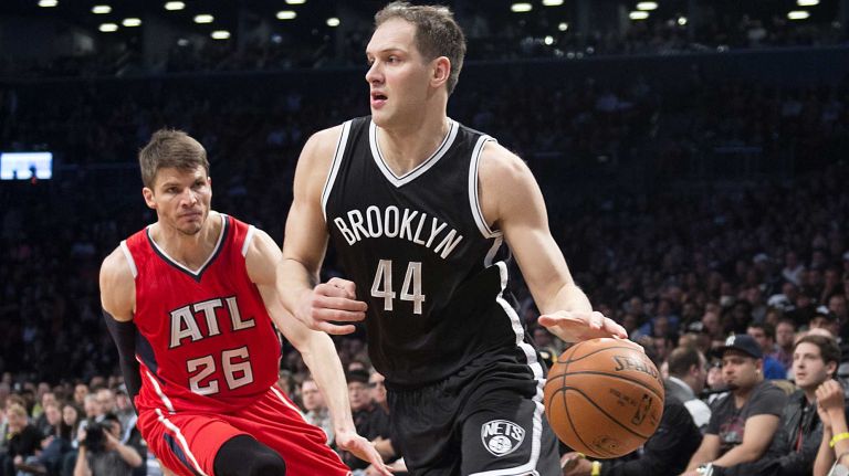 Brooklyn Nets' Bojan Bogdanovic drives to the basket past Kyle Korver of the Atlanta Hawks in the fourth quarter during Game 3 of the Eastern Conference quarterfinals at Barclays Center on Saturday, April 25, 2015.