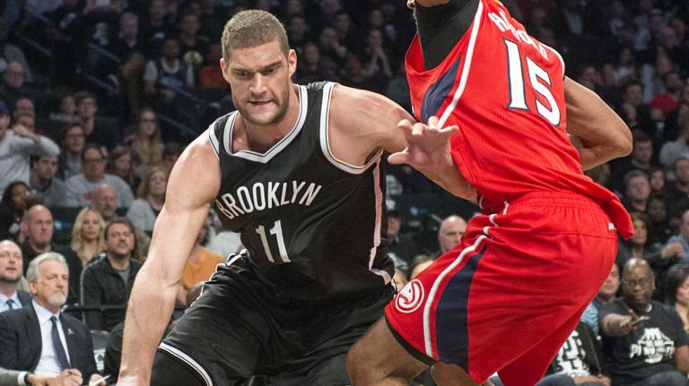 Brooklyn Nets' Brook Lopez drives against Al Horford of the Atlanta Hawks in the fourth quarter during Game 3 of the Eastern Conference quarterfinals at Barclays Center on Saturday, April 25, 2015.