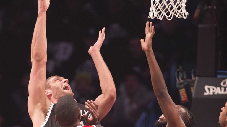Brooklyn Nets' Brook Lopez shoots over the defense of the Atlanta Hawks in the first quarter during Game 3 of the Eastern Conference quarterfinals at Barclays Center on Saturday, April 25, 2015.