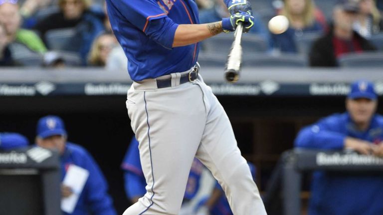 New York Mets shortstop Wilmer Flores hits an RBI single to left during the fourth inning of a baseball game against the New York Yankees at Yankee Stadium on Saturday, April 25, 2015.