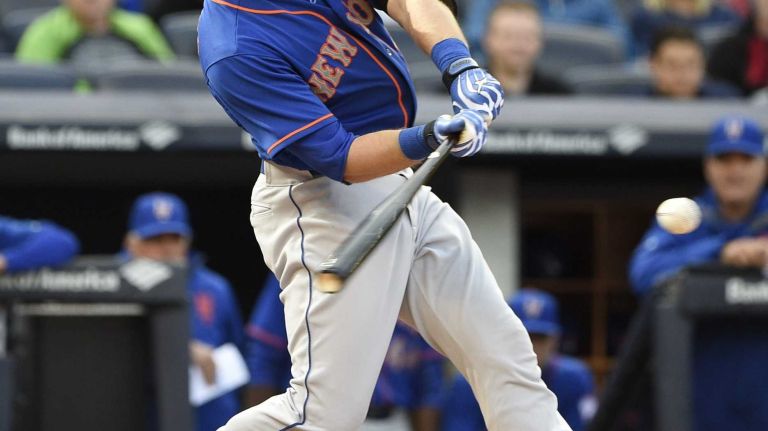 New York Mets catcher Kevin Plawecki hits a two-run home run during the fourth inning against the New York Yankees in a baseball game at Yankee Stadium on Saturday, April 25, 2015.