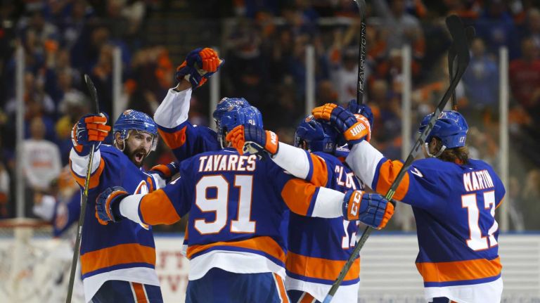 Eastern Conference quarterfinals Game 6: Islanders vs. Capitals 72 Cal Clutterbuck of the New York Islanders celebrates his third-period empty-net goal against the Washington Capitals with his teammates during Game 6 of the Eastern Conference quarterfinals at Nassau Coliseum on Saturday, April 25, 2015.