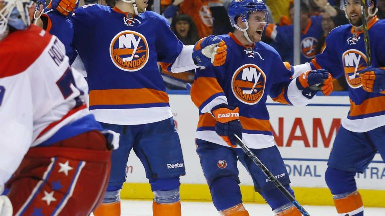 Eastern Conference quarterfinals Game 6: Islanders vs. Capitals 75 Nikolay Kulemin of the New York Islanders celebrates his third-period goal against Braden Holtby of the Washington Capitals with teammates Colin McDonald and Thomas Hickey during Game 6 of the Eastern Conference quarterfinals at Nassau Coliseum on Saturday, April 25, 2015.
