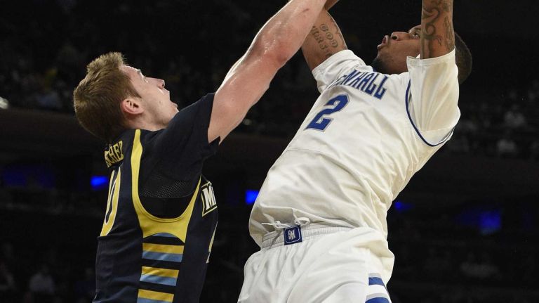 Big East Tournament first round: Marquette vs. Seton Hall 46 Seton Hall Pirates forward Brandon Mobley is fouled by Marquette Golden Eagles center Luke Fischer in the first round of the Big East basketball tournament at Madison Square Garden on Wednesday, March 11, 2015.