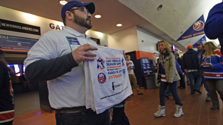 Fans at Islanders vs. Rangers 32 Brandon Lawson raises money for charity selling Islanders-Rangers towels at Nassau Coliseum during the last Islanders-Rangers regular-season game at the Coliseum on March 10, 2015.