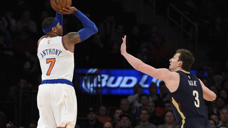 New York Knicks forward Carmelo Anthony sinks a three-pointer past New Orleans Pelicans center Omer Asik in the first half of an NBA game at Madison Square Garden on Monday, Jan. 19, 2015.