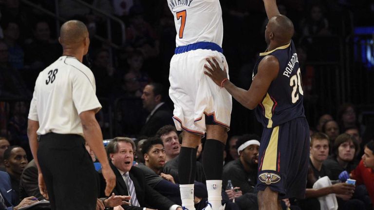 New York Knicks forward Carmelo Anthony sinks a three-pointer past New Orleans Pelicans guard Quincy Pondexter in the first half of an NBA game at Madison Square Garden on Monday, Jan. 19, 2015.