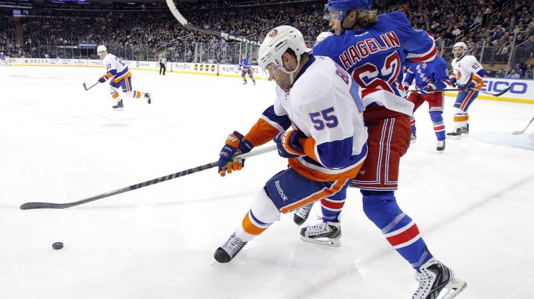 Johnny Boychuk of the New York Islanders defends against Carl Hagelin of the New York Rangers in the third period at Madison Square Garden on Tuesday, Jan. 13, 2015.
