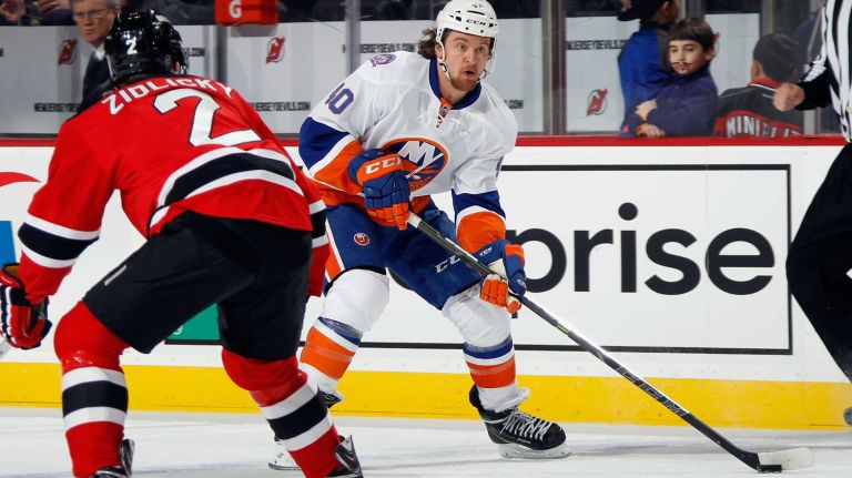 Michael Grabner of the New York Islanders skates against Marek Zidlicky of the New Jersey Devils at the Prudential Center on Jan. 9, 2015 in Newark, N.J.