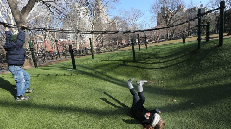 Addison, right, and Colton Fields, visiting from Atlanta, play on the green in Washington Square Park.