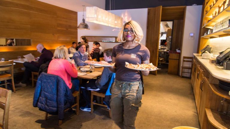 City Living: Chelsea 33 Zenobia Graham of East Elmhurst serves pizza at Co. in Manhattan's Chelsea neighborhood on March 29 ,2015.