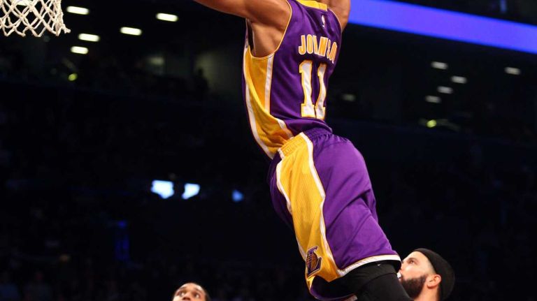 Los Angeles Lakers small forward Wesley Johnson dunks over Brooklyn Nets point guard Deron Williams during the third quarter at Barclays Center on Sunday, March 29, 2015.