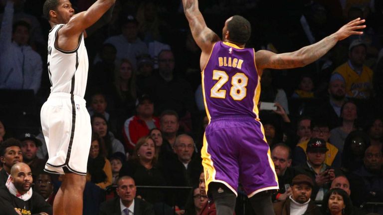 Brooklyn Nets small forward Joe Johnson shoots a three-point shot against Los Angeles Lakers power forward Tarik Black during the fourth quarter at Barclays Center on Sunday, March 29, 2015.