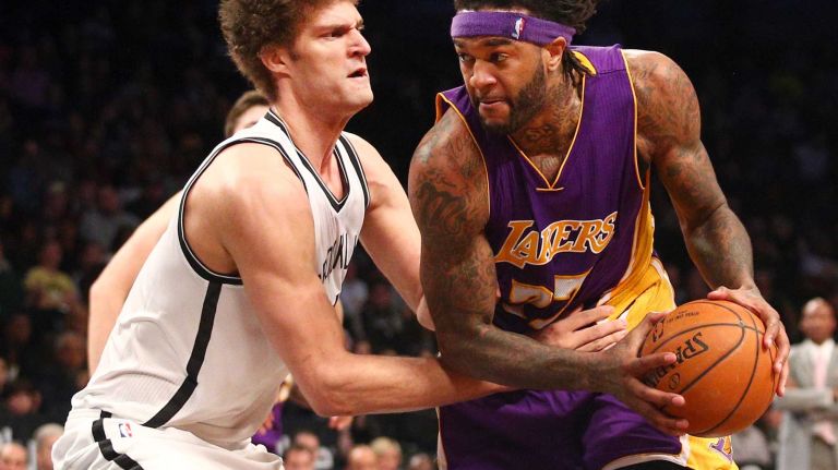 Brooklyn Nets center Brook Lopez defends against Los Angeles Lakers center Jordan Hill during the fourth quarter at Barclays Center on Sunday, March 29, 2015.