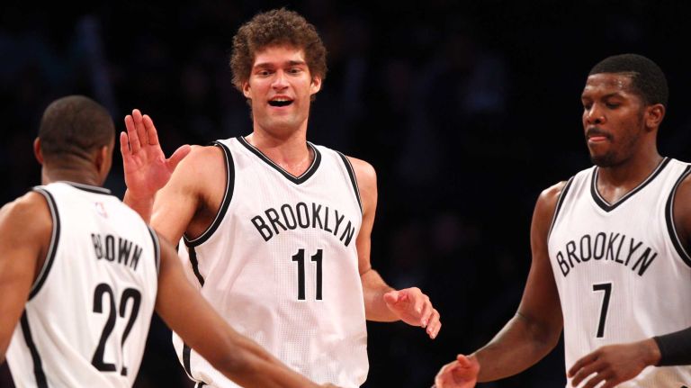 Brooklyn Nets center Brook Lopez #11 high0fives shooting guard Markel Brown #22 and small forward Joe Johnson #7 during the fourth quarter of a game against the Los Angeles Lakers at Barclays Center on Sunday, March 29, 2015.