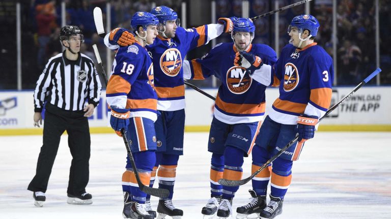 New York Islanders defenseman Johnny Boychuk, second from left, celebrates his goal against the Los Angeles Kings in the third period of an NHL hockey game at Nassau Coliseum on Thursday, March 26, 2015. The Kings defeated the Islanders 3-2.