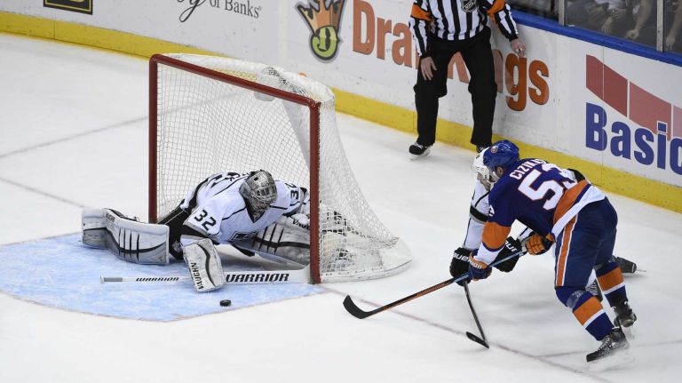 Los Angeles Kings goalie Jonathan Quick makes a save against New York Islanders center Casey Cizikas in the second period of an NHL hockey game at Nassau Coliseum on Thursday, March 26, 2015.