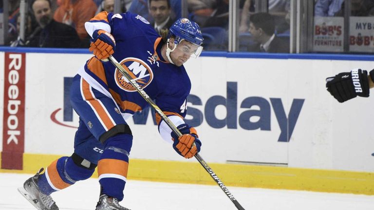 New York Islanders defenseman Calvin de Haan shoots against the Los Angeles Kings in the first period of an NHL hockey game at Nassau Coliseum on Thursday, March 26, 2015.