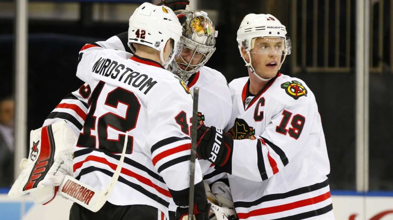 Scott Darling, Joakim Nordstrom and Jonathan Toews of the Chicago Blackhawks celebrate after defeating the New York Rangers at Madison Square Garden on Wednesday, March 18, 2015.