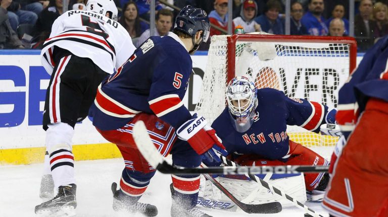 Cam Talbot and Dan Girardi of the New York Rangers defend the net in the second period against David Rundblad of the Chicago Blackhawks at Madison Square Garden on Wednesday, Mar. 18, 2015.