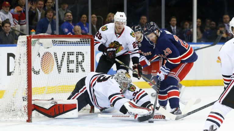 Scott Darling of the Chicago Blackhawks makes a save in the first period against Dominic Moore of the New York Rangers at Madison Square Garden on Wednesday, March 18, 2015.