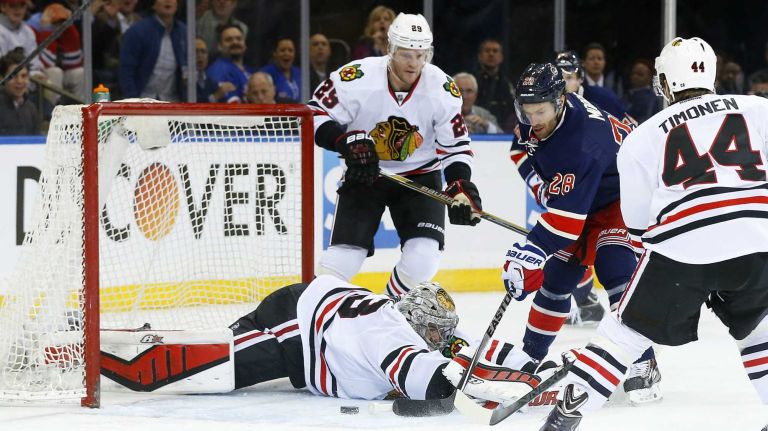 Scott Darling of the Chicago Blackhawks makes a save in the first period against Dominic Moore of the New York Rangers at Madison Square Garden on Wednesday, March 18, 2015.