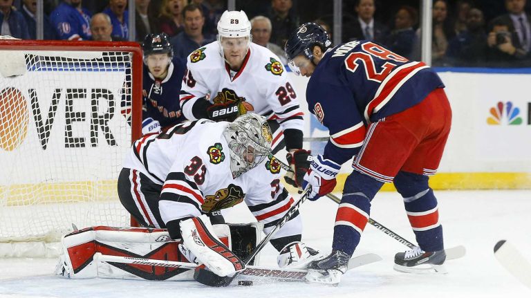 Scott Darling of the Chicago Blackhawks makes a save in the first period against Dominic Moore of the New York Rangers at Madison Square Garden on Wednesday, March 18, 2015.