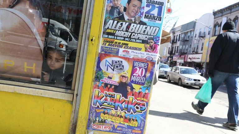 A little girl looks out of the window of the Vista Vision store at the corner of Knickerbocker and Dekalb in Bushwick.