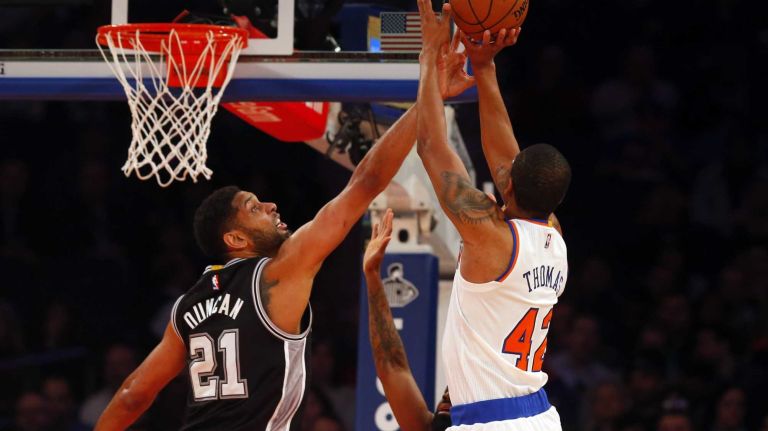 Lance Thomas of the New York Knicks shoots against Tim Duncan of the San Antonio Spurs during the first half at Madison Square Garden on Tuesday, March 17, 2015.