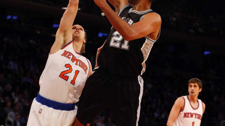 Tim Duncan of the San Antonio Spurs shoots over Lou Amundson of the New York Knicks during the first half at Madison Square Garden on Tuesday, March 17, 2015.