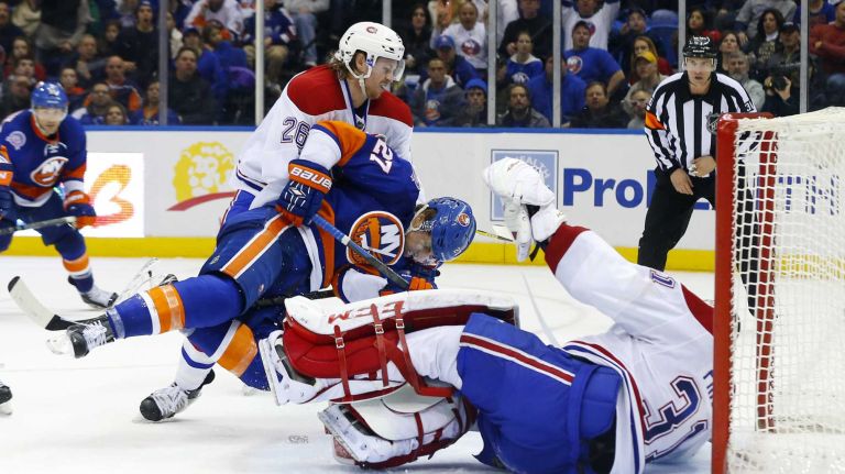 Jeff Petry and Carey Price of the Montreal Canadiens defend a third period scoring chance against Anders Lee #27 of the New York Islanders at Nassau Coliseum on Saturday, March 14, 2015 in Uniondale.