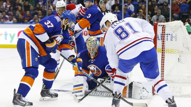 Michal Neuvirth and Brian Strait of the New York Islanders defend the net in the second period against Lars Eller of the Montreal Canadiens at Nassau Coliseum on Saturday, March 14, 2015 in Uniondale.