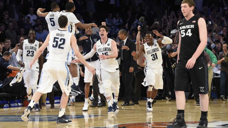 Villanova Wildcats celebrate after defeating the Xavier Musketeers for the Big East basketball championship at Madison Square Garden on Saturday, March 14, 2015. Xavier Musketeers forward/center Sean O'Mara reacts as he walks off.