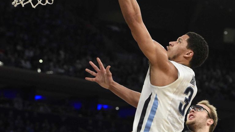 Villanova Wildcats guard Josh Hart scores on a layup as Xavier Musketeers center Matt Stainbrook looks on during the final game of the Big East basketball tournament at Madison Square Garden on Saturday, March 14, 2015.