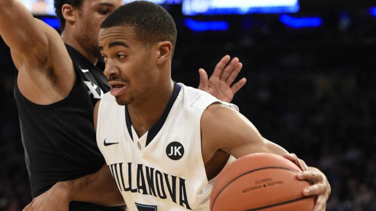 Villanova Wildcats guard Phil Booth drives the ball against Xavier Musketeers guard Dee Davis during the final game of the Big East basketball tournament at Madison Square Garden on Saturday, March 14, 2015.