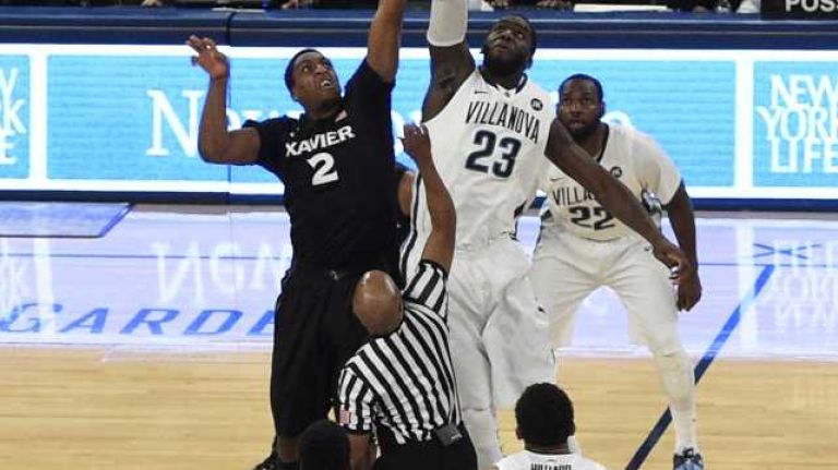 Xavier Musketeers forward James Farr and Villanova Wildcats forward JayVaughn Pinkston take the opening tipoff in the final game of the Big East basketball tournament at Madison Square Garden on Saturday, March 14, 2015.
