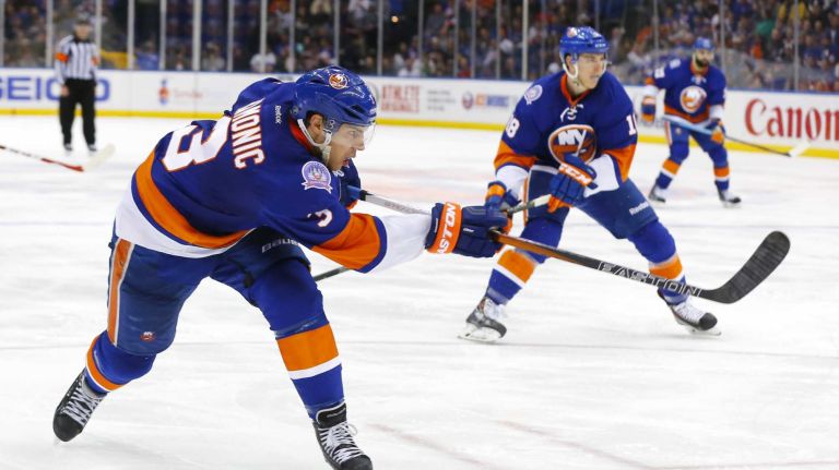 Travis Hamonic of the New York Islanders shoots the puck against the Ottawa Senators at Nassau Coliseum on Friday, March 13, 2015.