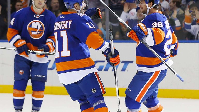 Tyler Kennedy of the New York Islanders celebrates his third period goal against the Ottawa Senators with teammate Lubomir Visnovsky at Nassau Coliseum on Friday, March 13, 2015.