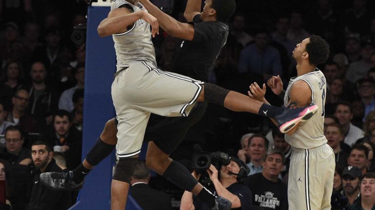 Big East Tournament semifinal: Georgetown vs. Xavier 29 Xavier Musketeers forward James Farr puts in a layup past Georgetown Hoyas forward Mikael Hopkins in a Big East semifinal men's basketball game at Madison Square Garden on Friday, March 13, 2015.