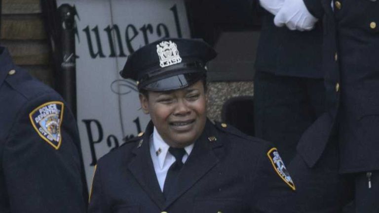 An officer from the 84th Precinct, where slain Dets. Wenjian Liu and Rafael Ramos were based, cries as she exits the wake held for Liu at Aievoli Funeral Home in Brooklyn on Saturday, Jan. 3, 2015. Liu and Ramos were shot and killed in their patrol car last month.