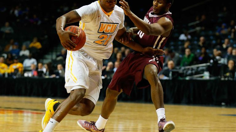 NEW YORK, NY - MARCH 12: Treveon Graham #21 of the Virginia Commonwealth Rams drives to the basket against Jon Severe #10 of the Fordham Rams during the Second Round of the Atlantic 10 Basketball Tournament at Barclays Center on March 12, 2015 in New York, New York. Virginia Commonwealth Rams defeated the Fordham Rams 63-57. (Photo by Mike Stobe/Getty Images)