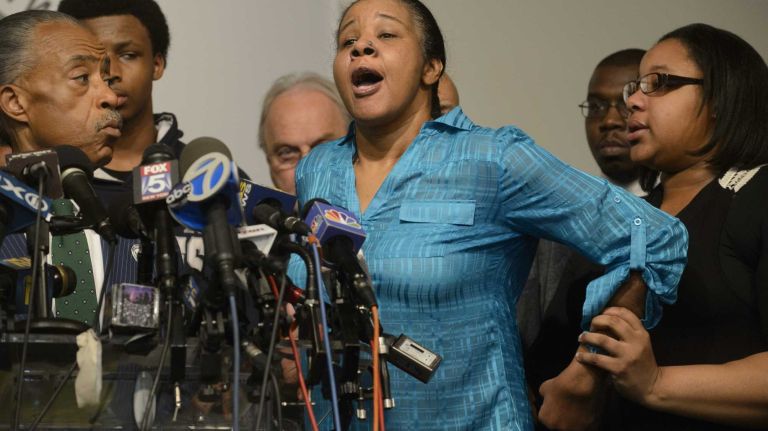 Esaw Garner, center, the wife of Eric Garner, speaks at a news conference at the National Action Network in Manhattan on Dec. 3, 2014, hours after a grand jury decided against indicting the NYPD officer involved in her husband's death on Staten Island during the summer. Eric Garner, 43, was put in an apparent chokehold by the officer, Daniel Pantaleo, as seen in a widely distributed bystander video. Police said Garner was selling loose, untaxed cigarettes and refused to be arrested, which led to the fatal confrontation. 