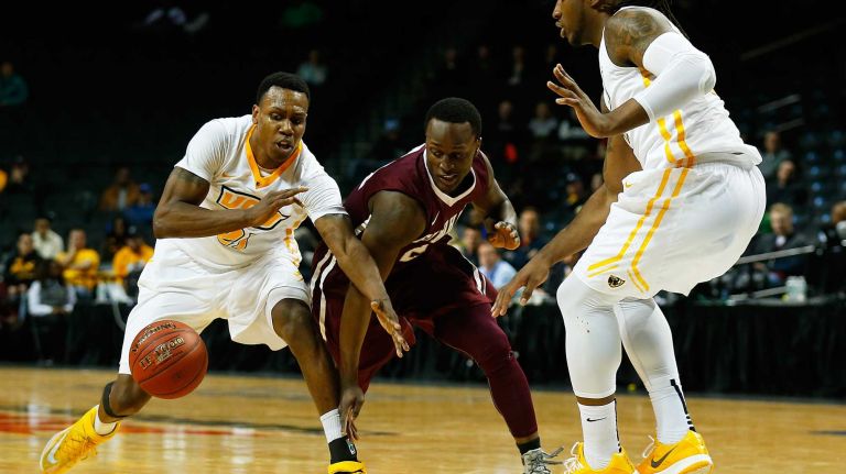 NEW YORK, NY - MARCH 12: JTreveon Graham #21 and Mo Alie-Cox #12 of the Virginia Commonwealth Rams defend against Bryan Smith #24 of the Fordham Rams during the Second Round of the Atlantic 10 Basketball Tournament at Barclays Center on March 12, 2015 in New York, New York. (Photo by Mike Stobe/Getty Images)