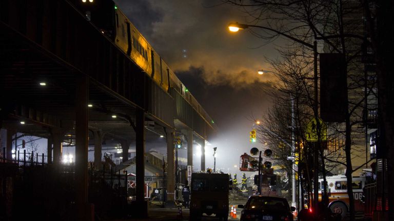 Smoke rises from the East Harlem scene where an explosion brought down two apartment buildings, killing eight people, on March 12, 2014.