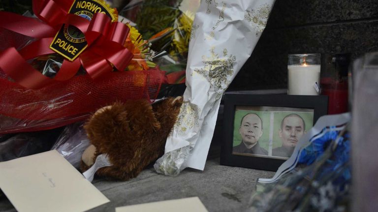 A memorial for two police officers who were shot and killed on Saturday, Dec. 20, 2014, lies outside the 84th Precinct in Brooklyn on Sunday, Dec. 21. Officers Wenjian Liu, 32, and Rafael Ramos, 40, were ambushed by Ismaaiyl Brinsley, 28, as they sat in their cruiser in the Bedford-Stuyvesant area of Brooklyn, police say.